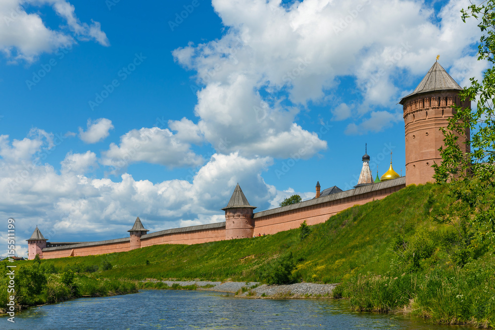 The walls and towers of Spaso-Evfimiev monastery on high Bank of the river in Suzdal