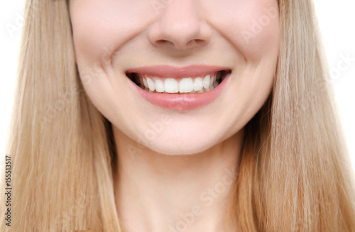 Smiling young woman on white background, close up