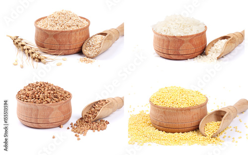 Collection of wheat porridge, organic millet seeds, buckwheat, rice in wooden bowl isolated on white background