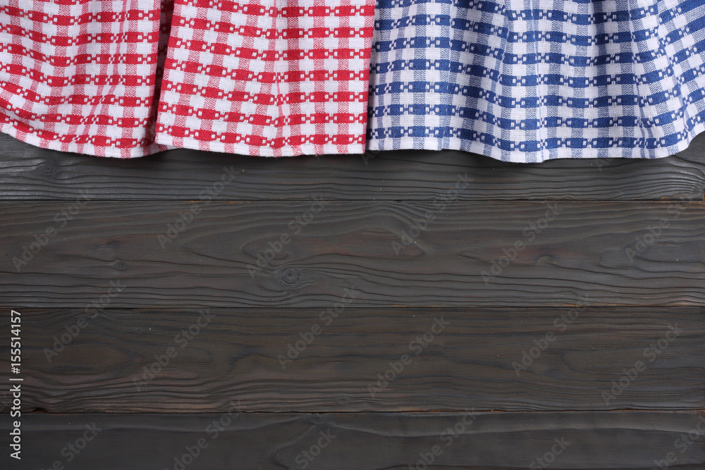 blue and red cloth on dark wooden background with copy space. Top view.