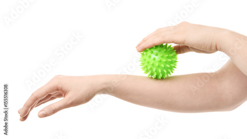 Hands of woman doing exercises with rubber ball on white background