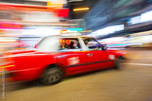 A taxi in motion under in the streets of Hong Kong