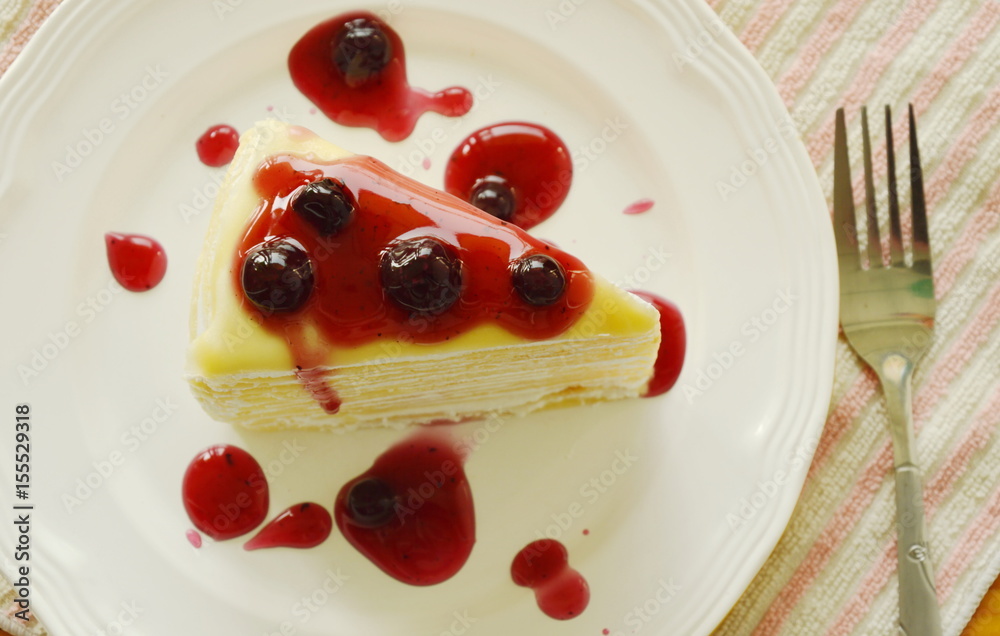 crape cake dressing blueberry sauce on dish crape cake dressing blueberry sauce on dish