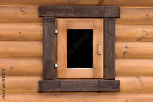 Window on the wall of a wooden house from calibrated logs
