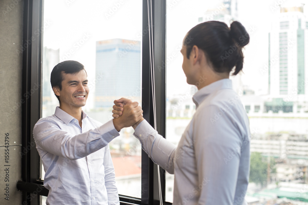 Businessman shaking hands greeting each other, 20-30 year old. Businessman shaking hands greeting each other, 20-30 year old.