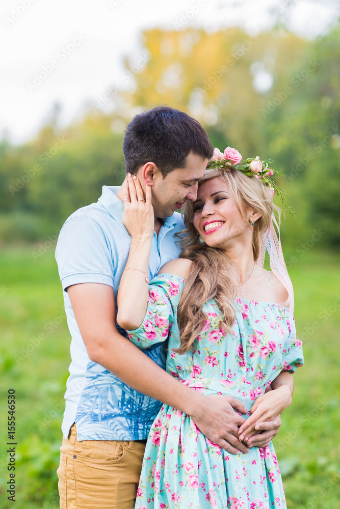 Couple embracing on the countryside. Young romantic man and woman standing and hugging each other with tenderness on nature. Young love concept. Couple embracing on the countryside. Young romantic man and woman standing and hugging each other with tenderness on nature. Young love concept.