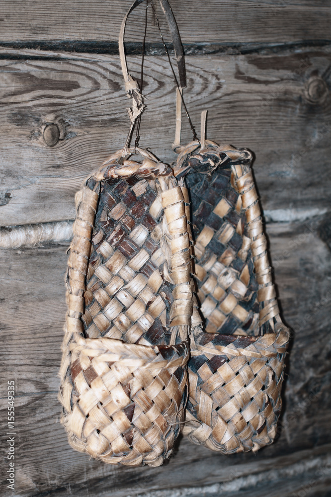 Footwear named lapty or bast shoes hanging on the wood wall (Sweden, Finland, Norway, Russia, Ukraine, Belarus etc.).....