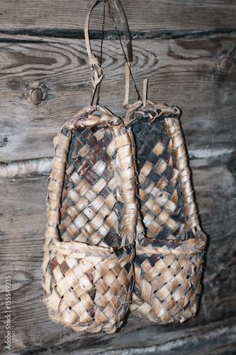 Obraz na płótnie Footwear named lapty or bast shoes hanging on the wood wall (Sweden, Finland, Norway, Russia, Ukraine, Belarus etc.)..... w salonie