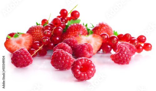 vitamin collection of berries: sour a currant, ripe red a strawberry with leaves and a sweet raspberry isolated on a white background