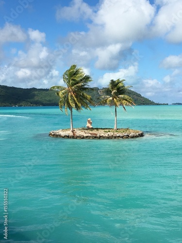 Welcome at the airport harbour of Bora Bora, showing a small artificial island with two palm trees and a small sculpture, Bora Bora, Tahiti, French Polynesia