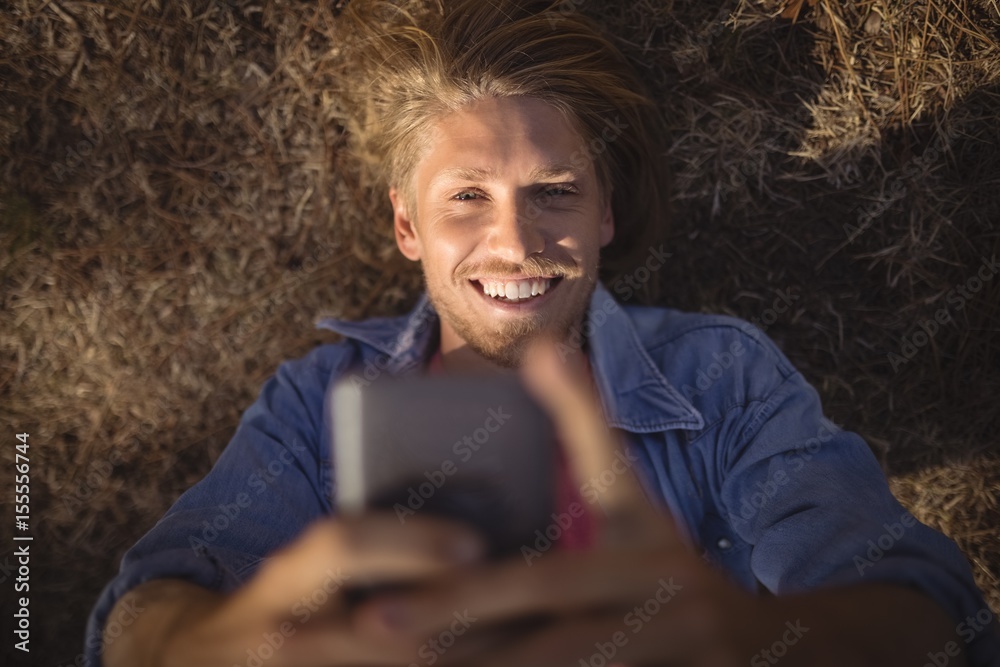 Overhead view of man smart phone while lying Overhead view of man smart phone while lying