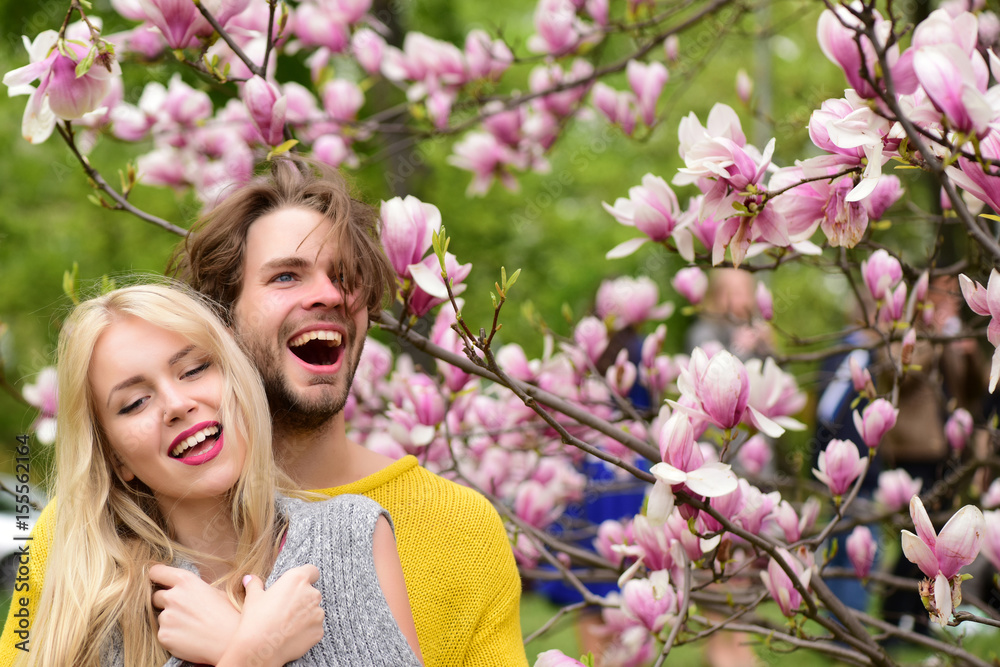 Fototapeta premium happy couple in love in spring magnolia flowers