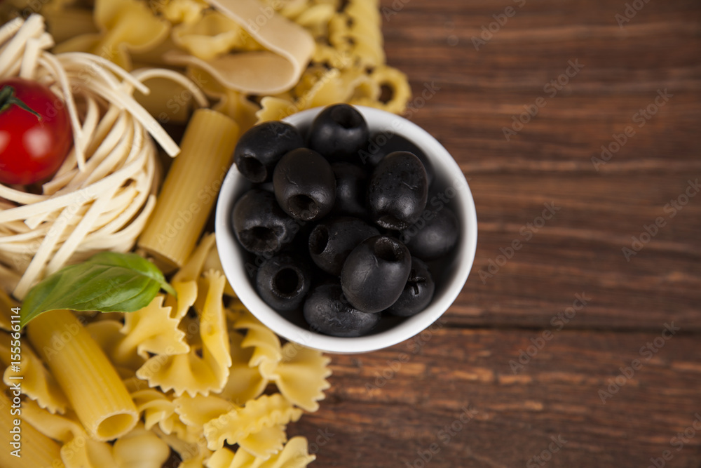 Dry pasta with ingredients on a old wood Dry pasta with ingredients on a old wood