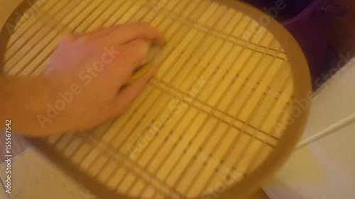 the human hand raises the lid of the basket for dirty Laundry and throws the dirty clothes.