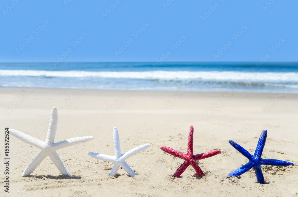 Patriotic USA background with starfishes on the sandy beach Patriotic USA background with starfishes on the sandy beach