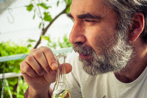 Bearded man drinking brandy photo