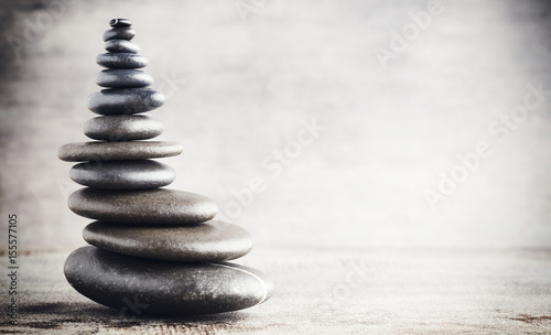 Balancing stones on the grey background.