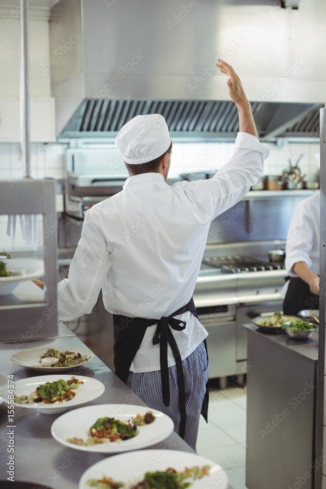 Chef preparing food in the commercial kitchen Chef preparing food in the commercial kitchen
