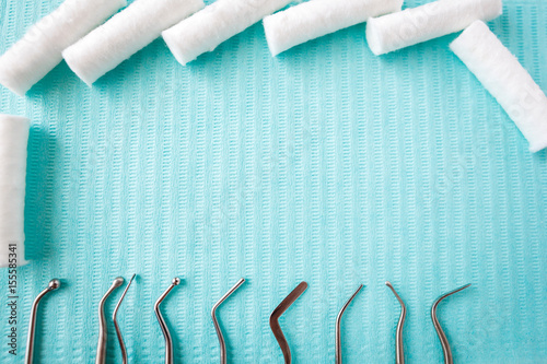 dental cotton rolls, instruments on the napkin. Top view with copy space for text. Dentist equipment, Stomatology. photo