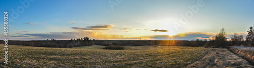 Panorama landscape. Sunset above the field and forests.