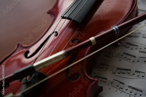 Close up of brown violin with sheet music