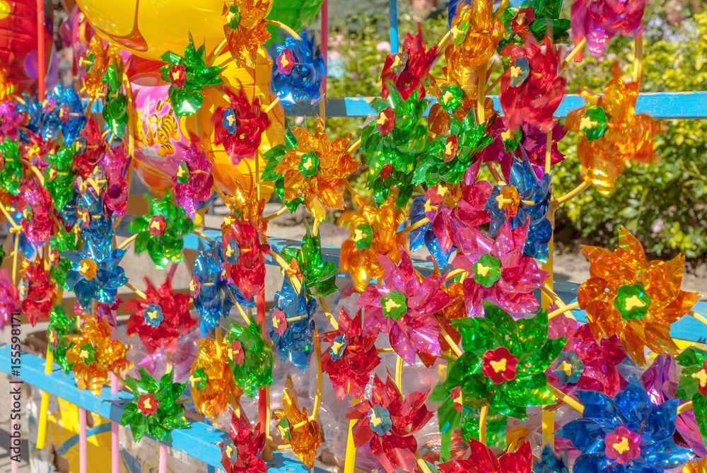 a lot of beautiful colored pinwheels, rotating toys, background, focus selection