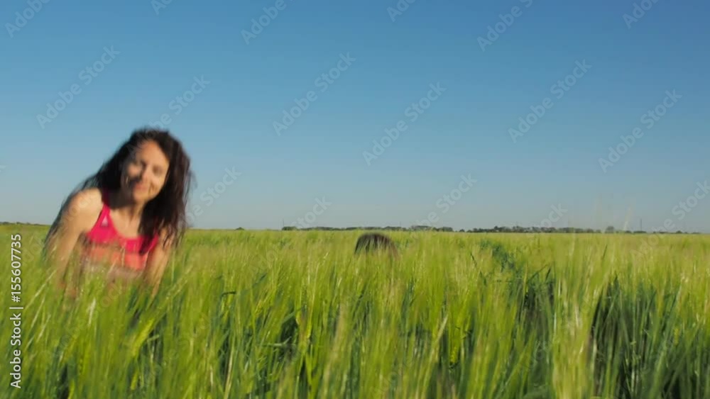 A woman with a child hides in the wheat. Happy family playing on the wheat field. A woman with a child hides in the wheat. Happy family playing on the wheat field.