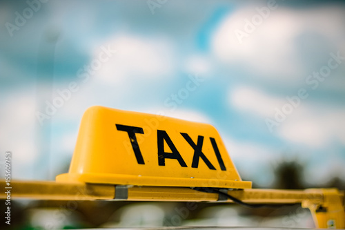 A taxi sign with blurred background