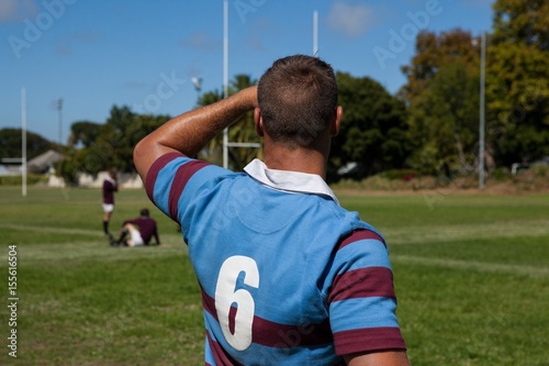 Rear view of rugby player at playing field