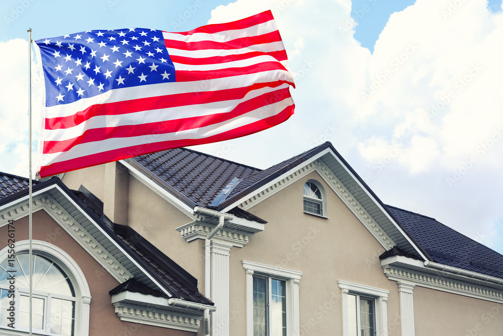 Waving USA flag and house on background