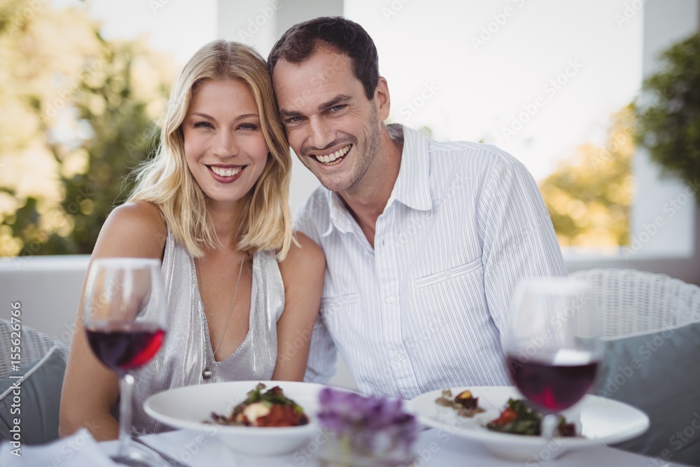 Romantic couple sitting together in restaurant