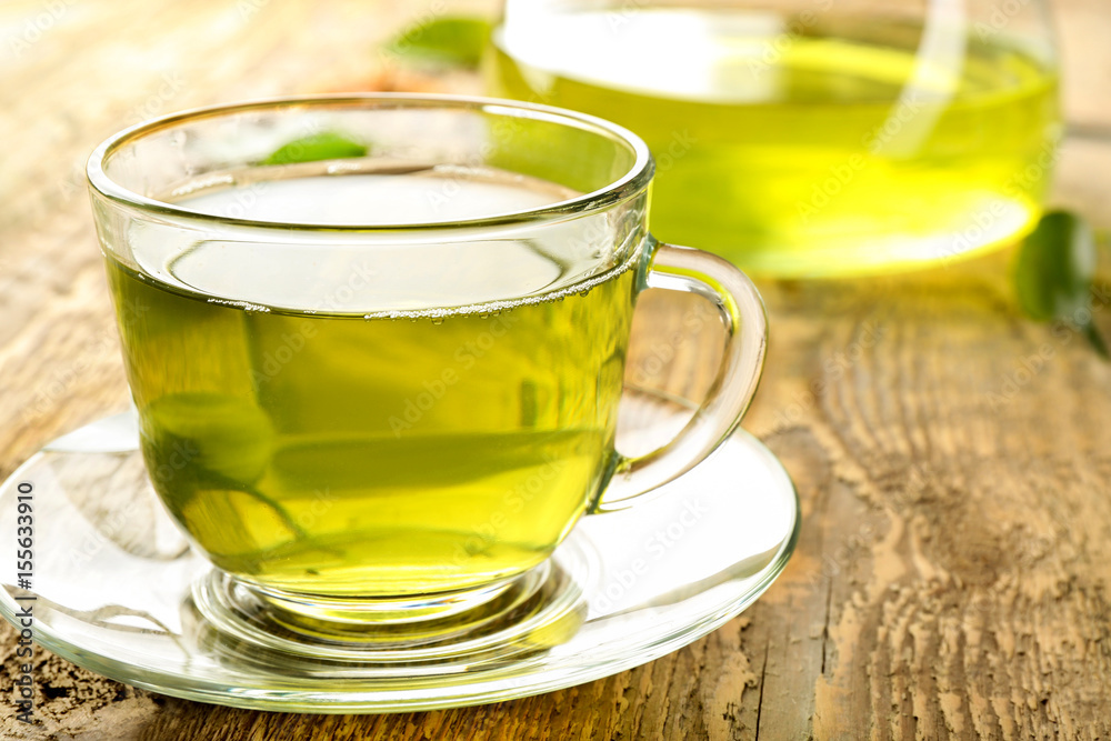 Cup of green tea on wooden table Cup of green tea on wooden table