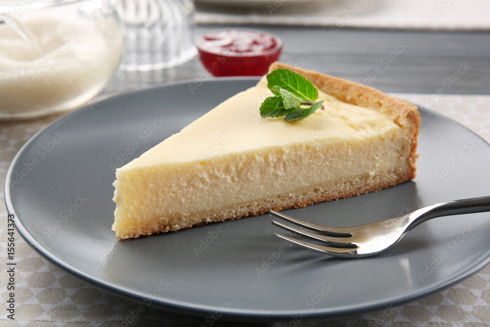 Plate with piece of tasty cheesecake on table, closeup Plate with piece of tasty cheesecake on table, closeup