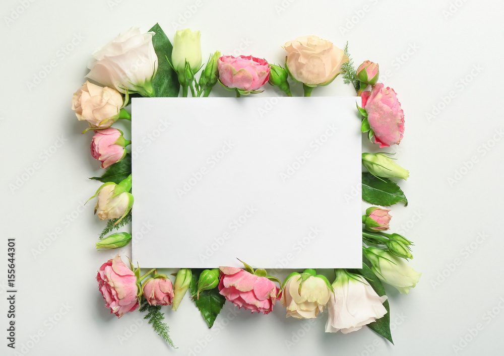 Beautiful flowers and green leaves as floral frame and paper card on white background Beautiful flowers and green leaves as floral frame and paper card on white background