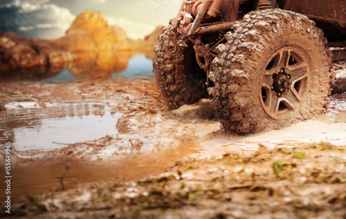 Off road vehicle coming out of a mud hole hazard,Travel and racing concept for four wheel drive off road vehicle .