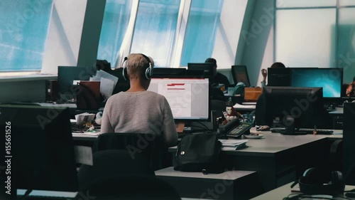 A journalist working on a computer in Newsroom