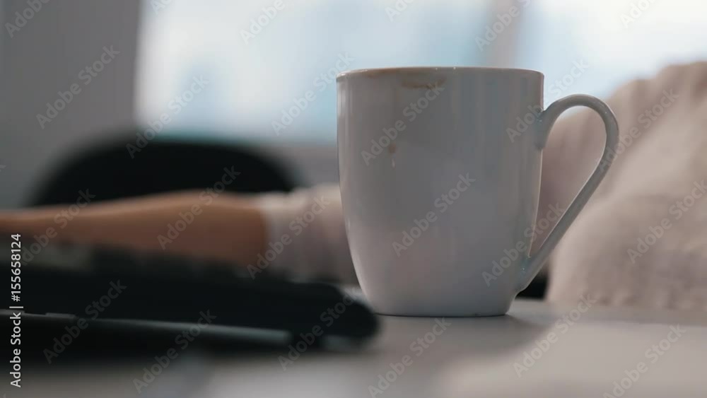 Coffee mug on the table with a journalist Coffee mug on the table with a journalist