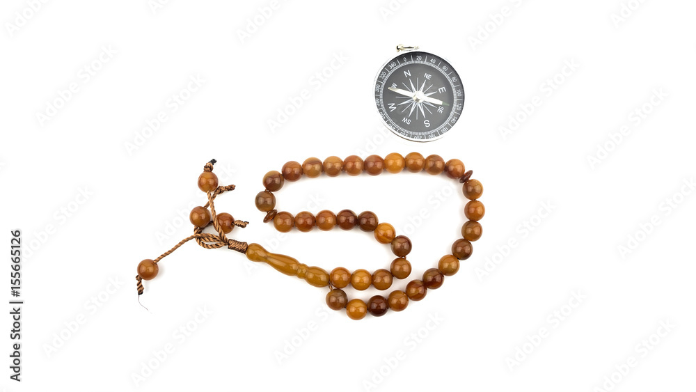 Prayer beads with compass on white background Prayer beads with compass on white background