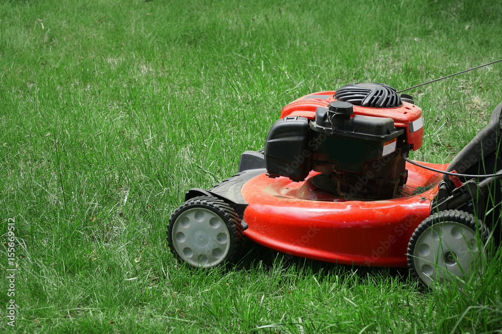 close up on lawn mower on green lawn close up on lawn mower on green lawn