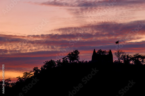 Silhouette temple on the mountain hill with twilight  cloudy sky background landscape © Sync