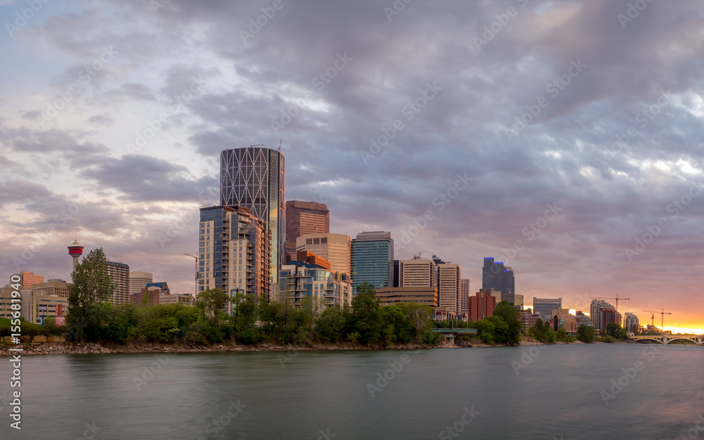 Calgary skyline along the Bow river at sunset.