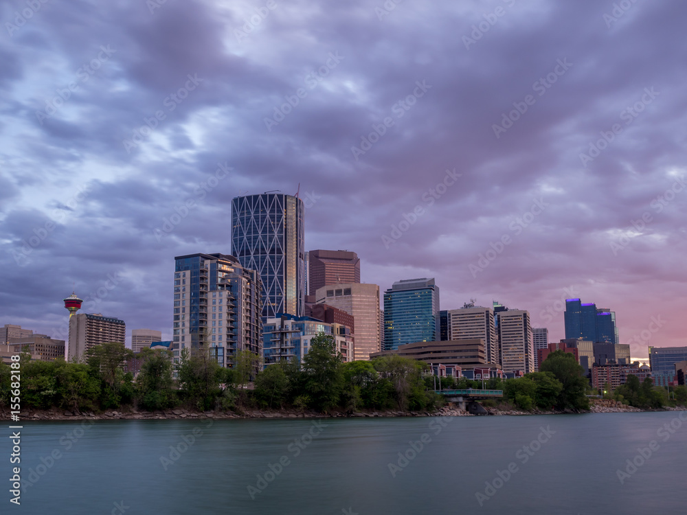 Calgary skyline along the Bow river at sunset.