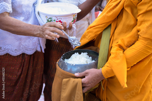 Photography Buddhist monk in south of Vietnam stand in a row waiting people put rice and foo
