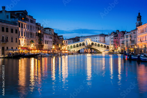 Ponte Rialto and gondola at sunset in Venice  Italy