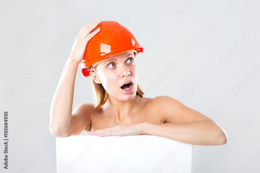 Emotional woman in a construction helmet. Concept of construction. Worker. Emotional woman in a construction helmet. Concept of construction. Worker.