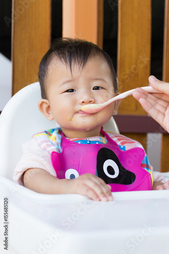 Asian cute baby eating food.
