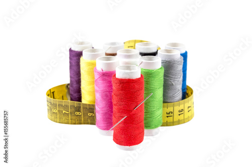 Colorful sewing threads with measuring tape isolated on white background.