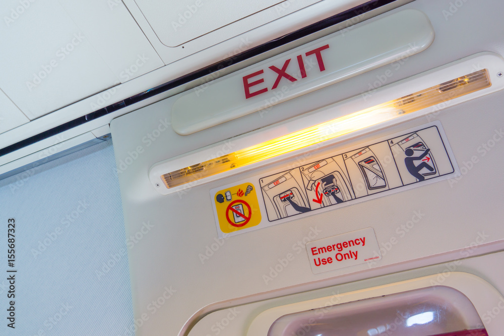 Exit sign and symbols in an aircraft cabin