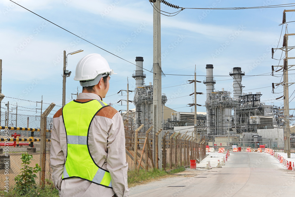Back view of Male construction worker against gas separation plant. Back view of Male construction worker against gas separation plant.