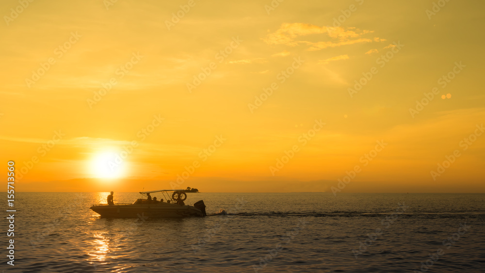 Evening view of the beach with small sailing, sunset scene Evening view of the beach with small sailing, sunset scene